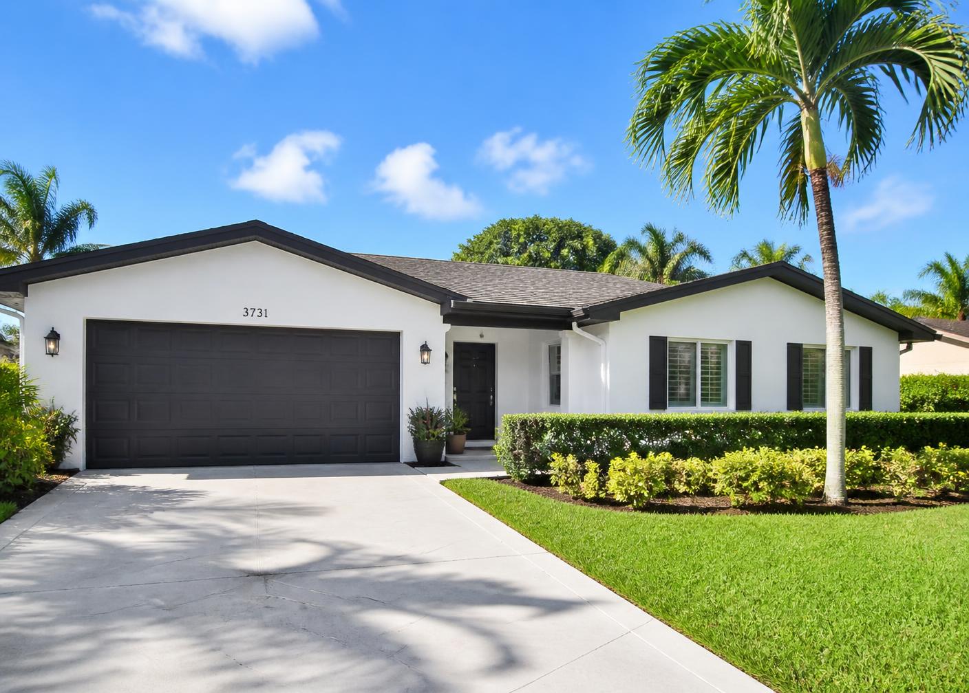 Single story Florida home after a full exterior repaint in warm white