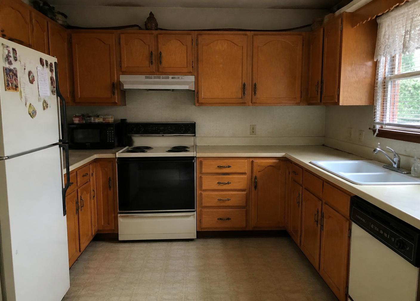 Dated honey oak kitchen cabinets before refinishing